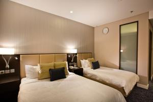 Uma cama ou camas num quarto em Ambassador Transit Hotel - Terminal 3