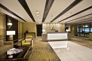 a lobby of a hotel with a sign on the wall at Ambassador Transit Hotel - Terminal 3 in Singapore