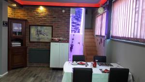 a dining room with two tables and a brick wall at Hostel IN Club in Zagreb