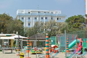 a playground in front of a large white building at Hotel Mirage in Lido di Classe