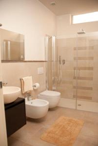a bathroom with a shower and a toilet and a sink at Il Marlo Suite & Breakfast in Marina di Carrara