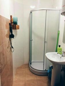 a bathroom with a shower, sink, and toilet at Capsularhouse Hostel in Dnipro
