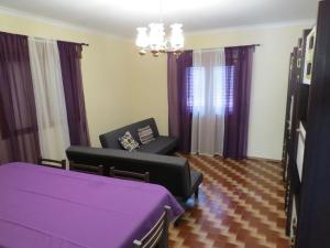 sala de estar con mesa y sillas de color púrpura en Quinta Machado Da Pedra Bela, en Gerês