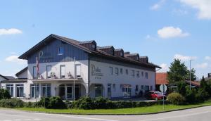 a large white building on the side of a road at Hotel Palko in Dingolfing