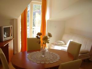 a living room with a table and a couch at Apartments Vlasic in Ston