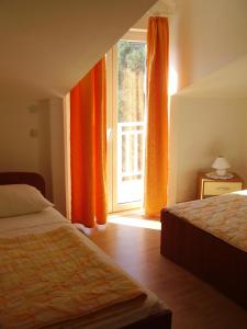 1 dormitorio con 2 camas y ventana abierta en Apartments Vlasic, en Ston