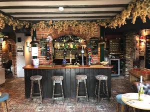 a bar in a restaurant with stools at Playden Oasts Hotel in Rye