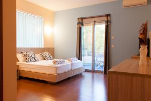 1 dormitorio con 1 cama y puerta corredera de cristal en Hotel Blue Moon, en Ulcinj