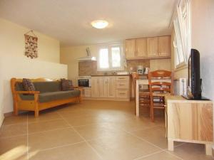 a living room with a couch and a kitchen at Villas Zoe in Skiathos