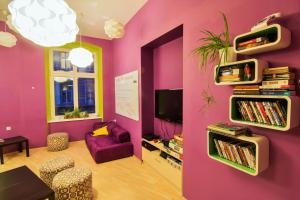 a living room with a purple wall at Grampa's Hostel in Wrocław