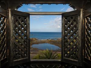 
a view out of a window of a balcony overlooking the water at Apartamentos Baja Del Secreto in Valle Gran Rey
