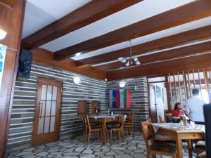 a dining room with wooden tables and chairs at Boeritza Hotel Complex in Vladaya