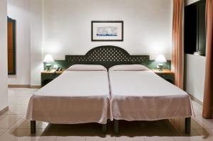 a bedroom with a large bed with two pillows at Apartamentos Baja Del Secreto in Valle Gran Rey