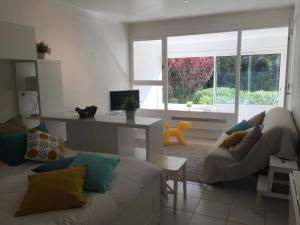 a living room with a couch and a window at Entre mer et mer in La Seyne-sur-Mer