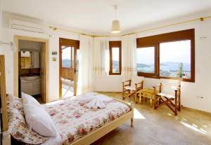 a bedroom with a bed and a table and chairs at Villas Zoe in Skiathos