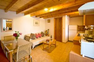 a living room with a couch and a table at Villas Zoe in Skiathos