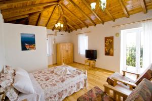 a bedroom with a bed and a tv in it at Villas Zoe in Skiathos