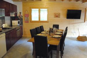 a kitchen with a wooden table with chairs around it at Christelle et Laeticia in Gérardmer