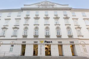 a white building with a root sign in front of it at Ruby Lissi Hotel Vienna in Vienna