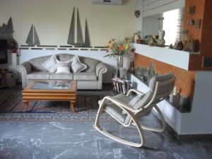 a living room with a couch and a coffee table at La Santre Villa in Amoudara Herakliou