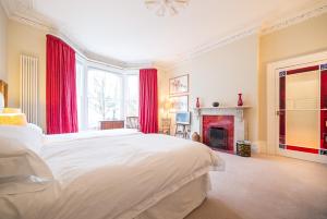 a bedroom with a large bed and a fireplace at The Bockery Suite 1 Chelsea in London