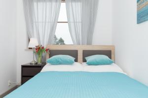 Posteľ alebo postele v izbe v ubytovaní Jantar Apartamenty City Center