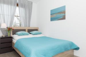 Posteľ alebo postele v izbe v ubytovaní Jantar Apartamenty City Center