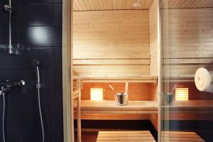 a sauna with a glass door in a bathroom at Nallikari Seaside Villas in Oulu +71 photos