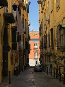 a car parked in an alley between buildings at Casa del Plebiscito in Naples