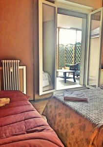 a bedroom with a bed and a sliding glass door at B&B Le Terrazze in Bologna
