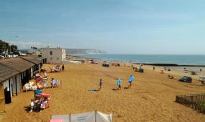 a group of people on a beach near the ocean at The Sandown - Seafront, Sandown, Isle of Wight - CAR FERRY TICKET from 109 Pounds in Sandown +36 photos