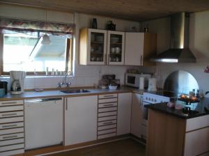 a kitchen with white cabinets and a sink at Mit Bed & Breakfast in Kolding