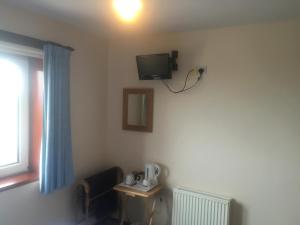 TV a/nebo společenská místnost v ubytování Invernettie guesthouse
