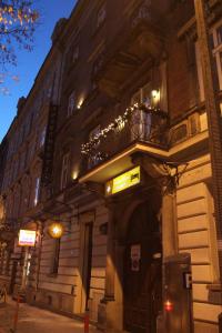 a building with a balcony on a street at night at Ventus Rosa Apartments in Krakow