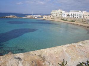 a large pool of water next to a beach at Casa Galli on the Seafront in Gallipoli