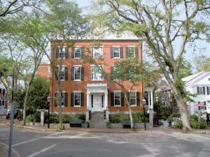 a large red brick building with a white door at Jared Coffin House in Nantucket