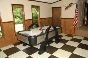 a jacuzzi tub in a room with a flag at Carolina Landing Camping Resort Cabin 14 in Fair Play