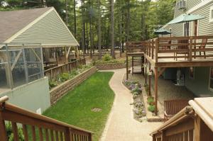 an aerial view of a backyard with a deck and grass at Gateway to Cape Cod Vacation Cottage 1 in Rochester