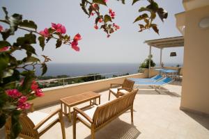 a balcony with benches and a view of the ocean at Villa Le Terrazze plus Pool in Gagliano del Capo