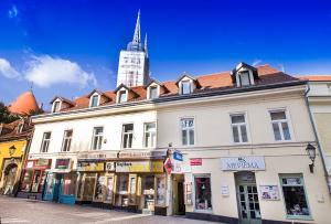 a large white building with a clock tower in the background at Hostel Centar in Zagreb