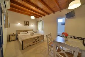 a bedroom with a bed and a table in a room at Amorgion Village in Katapola