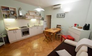 a kitchen with a table and a dining room at Sunny apartment in Zadar