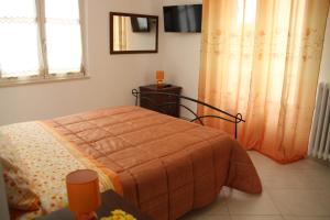 a bedroom with a bed with an orange blanket at Stella in Ascoli Piceno