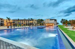 a large swimming pool with buildings in the background at Royalton Negril, An Autograph Collection All-Inclusive Resort in Negril