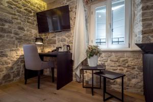 a room with a desk and a window at Murum Heritage Hotel in Split