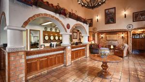 a large kitchen with a counter and a table at Best Western Casa Grande Inn in Arroyo Grande