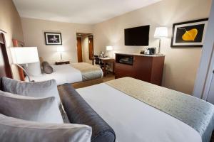 a hotel room with two beds and a television at Best Western Plus Peak Vista Inn & Suites in Colorado Springs