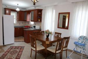 a kitchen with a table and chairs and a refrigerator at Dalyan Villa in Dalyan