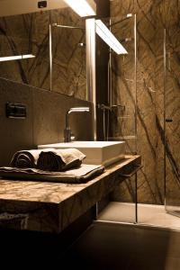 a bathroom with a sink and a mirror at Alexander Charme Hotel in Livigno