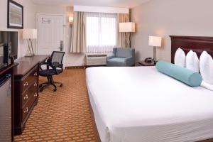 a hotel room with a large bed and a desk at Best Western International Drive - Orlando in Orlando
